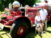 Marilyn and Dick Streissguth of Hazel Dell, with their dog Maggie, and a 1927 Ahrens-Fox fire engine.