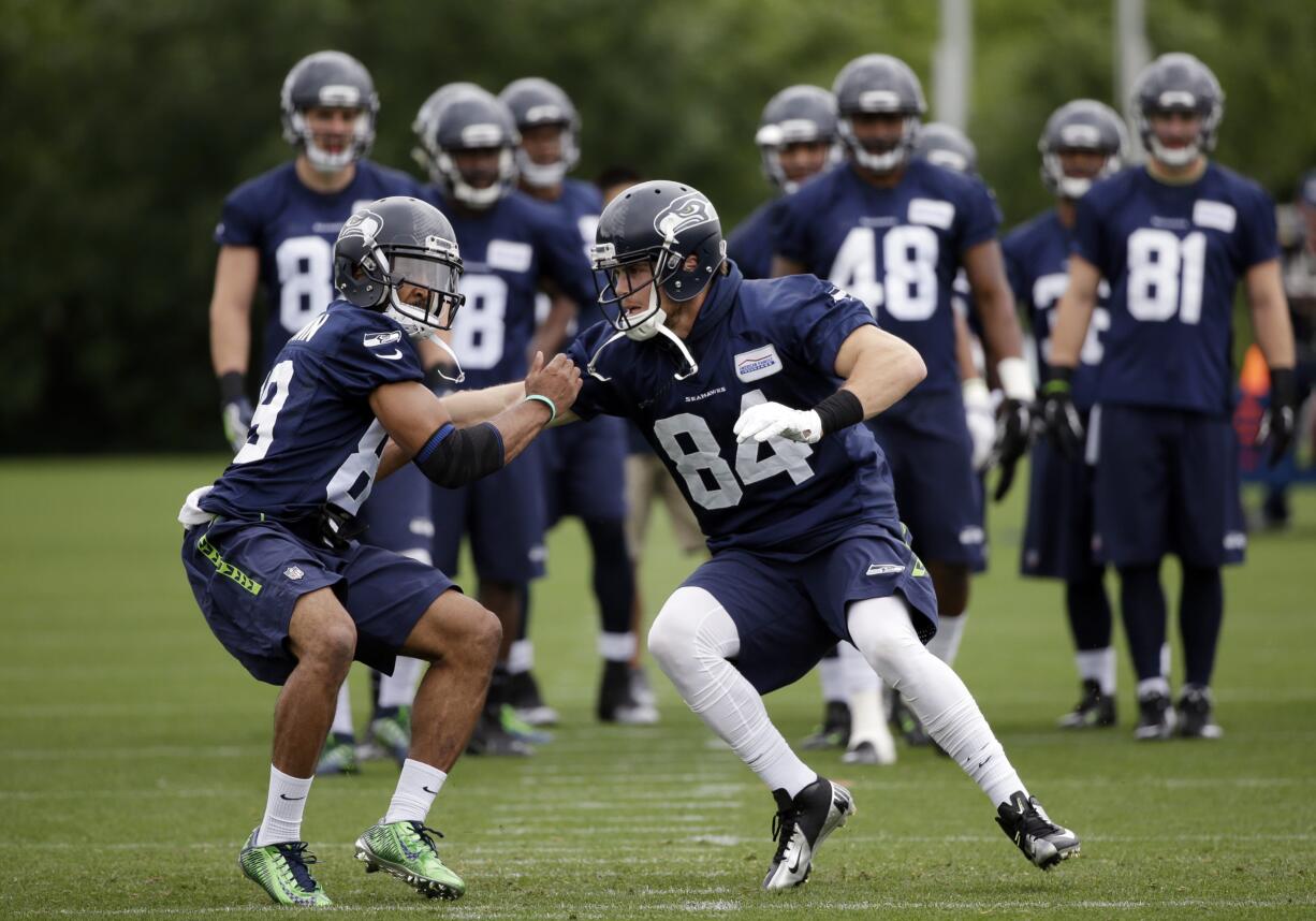 Seattle Seahawks' Doug Baldwin, left, and Cooper Helfet run through a drill at NFL football practice Thursday, May 26, 2016, in Renton, Wash.