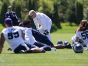 Head coach Pete Carroll talks to players as they stretch during the first day of the Seattle Seahawks NFL football rookie minicamp on Friday, May 6, 2016 at Virginia Mason Athletic Center in Renton, Wash.