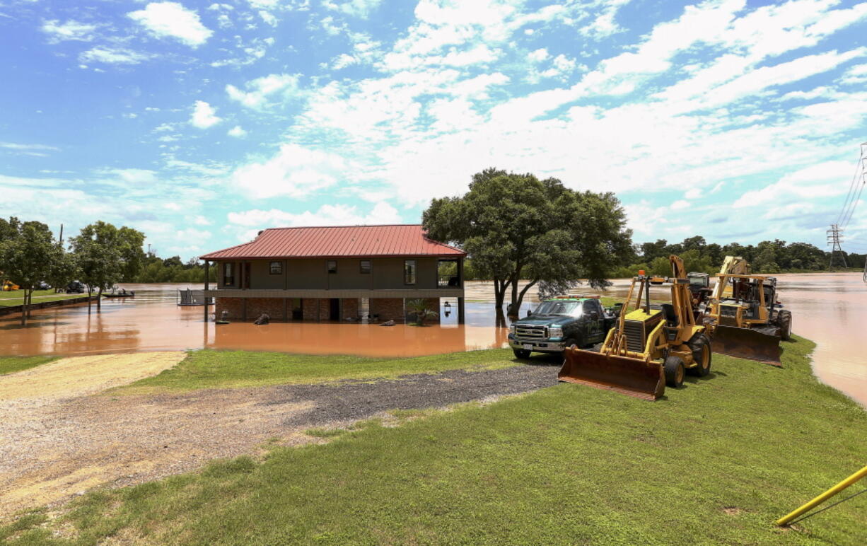 A home under construction is flooded as the Brazos River continues to rise Sunday in Rosenberg, Texas.