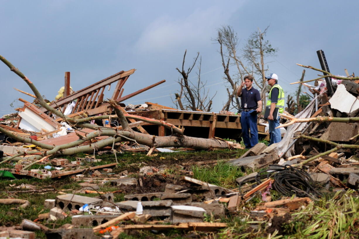 Meteorologists with the National Weather Service inspect the destruction Thursday morning, May 25, 2016, of a rural home north of Abilene, Kan. The home was destroyed Wednesday night by a tornado the stayed on the ground for 90 minutes and 25 miles.