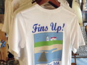 A shark-themed T-shirt is on sale in a souvenir shop in Harwich, Mass.