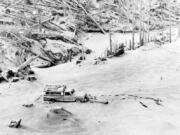 A camper containing two victims of the Mount St. Helens eruption sits amid the gray landscape about 8 miles from the mountain on May 20, 1980. Markings in the ash were made by a helicopter and a searcher who found the victims.