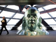 A person walks past a sculpture of Benjamin Franklin at the One Liberty Observation Deck in Philadelphia. The City of Brotherly Love will get a lot of attention later this summer during the Democratic National Convention, with attractions ranging from American history classics to new parks and outdoor venues.