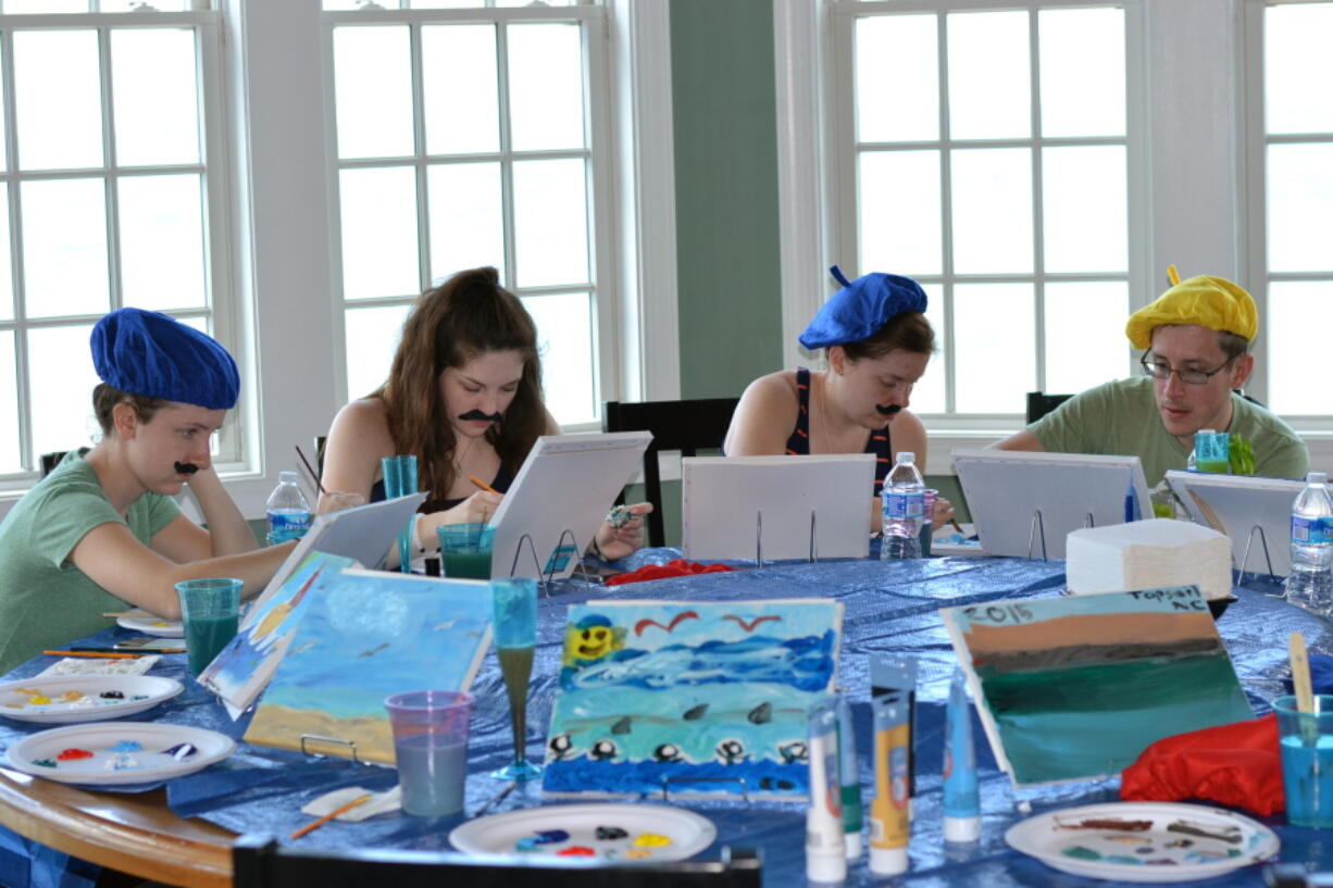 Nicole Nussbaum, Katie Pollack, Kristen Nussbaum and Robert Nussbaum paint vacation scenes as part of an Easel Like Sunday Morning-themed Sunday brunch in June at a vacation home in North Topsail Beach, N.C.