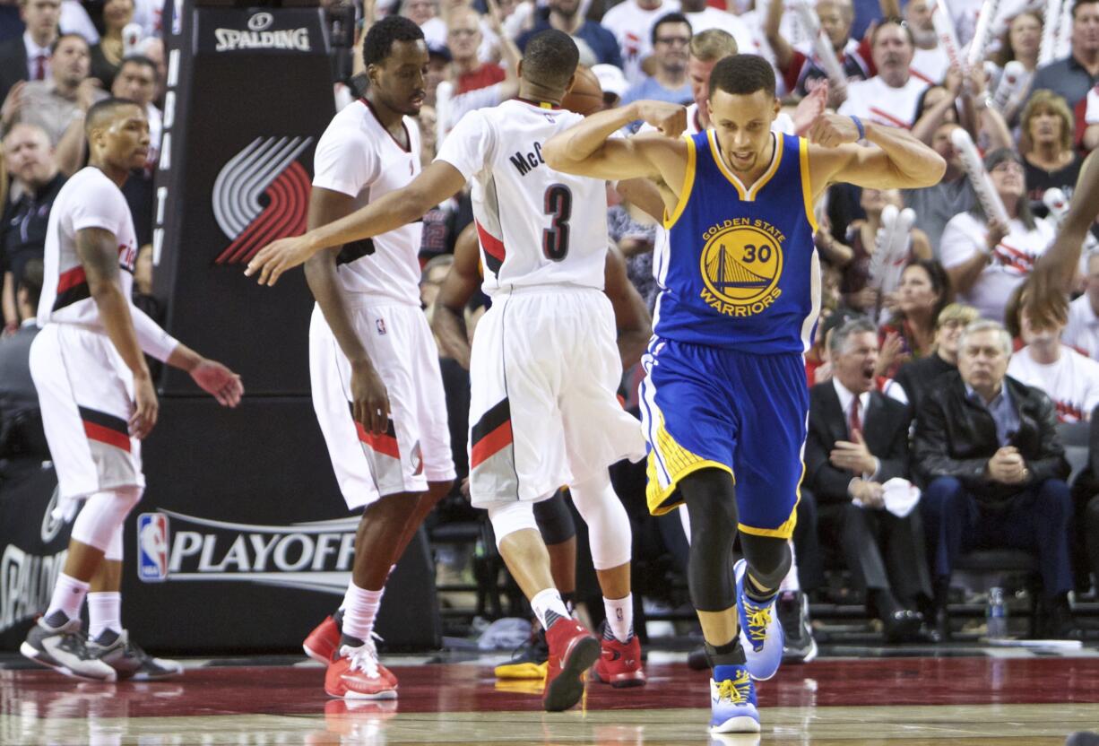 Golden State Warriors guard Stephen Curry (30) reacts after scoring a basket against the Portland Trail Blazers during the second half of Game 4 of an NBA basketball second-round playoff series Monday in Portland.