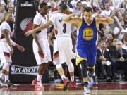 Golden State Warriors guard Stephen Curry (30) reacts after scoring a basket against the Portland Trail Blazers during the second half of Game 4 of an NBA basketball second-round playoff series Monday in Portland.