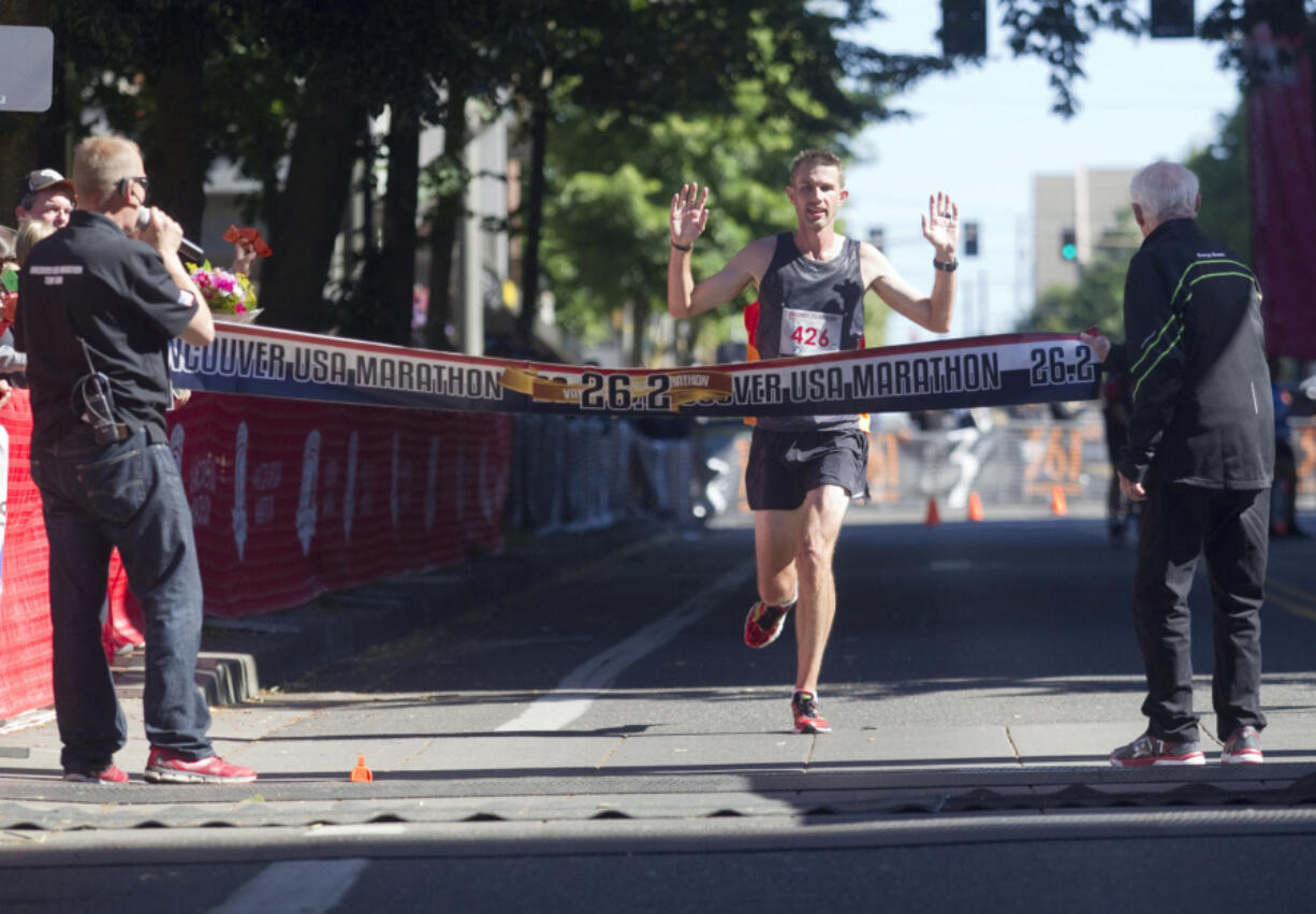 Brent Corbitt, the winner Vancouver Marathon, crosses the finish line in downtown Vancouver Sunday June 19 2016. Corbitt, from Arkansas, reported that this was his first marathon.