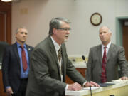 County Manager Mark McCauley, center, speaks to the crowd after proclaiming National County Government Month as Clark County Councilors David Madore, left, and Marc Boldt look on at an April Clark County council meeting at the Public Service Center. The council is granted McCauley a new, 18-month contract at Tuesday&#039;s meeting.