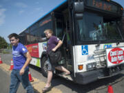 Darrin Breitmayer, left, was one of the passengers who took advantage of C-Tran&#039;s shuttle to the Clark County Fair last summer. The transit agency hopes special services such as the fair buses will attract more riders.