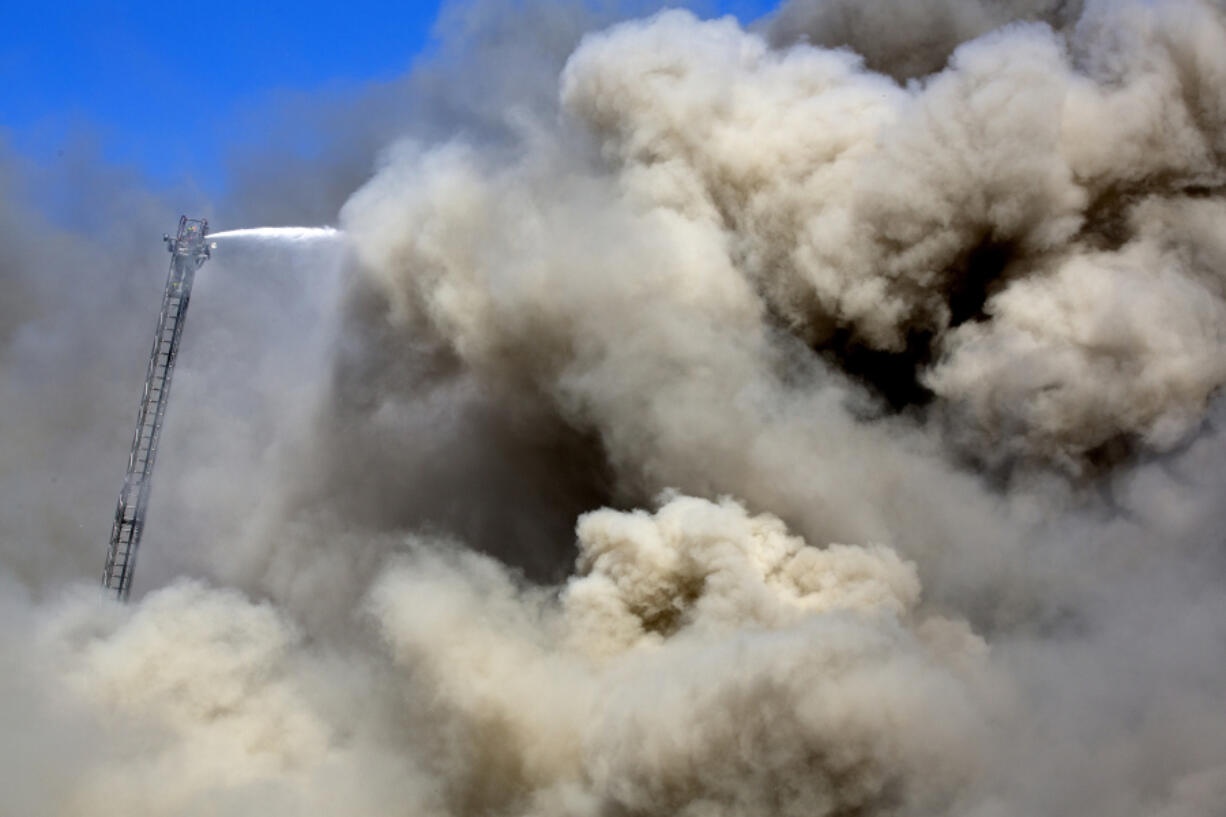 Firefighters battle a blaze Wednesday following an explosion in a scrap pile at All Metals Recycling in Madison, Wis.