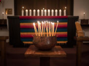 Vigil candles at St. Anne's Episcopal Church in Washougal are lit Wednesday evening to honor the victims of the Orlando shooting.