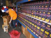 A worker stocks the TNT Fireworks warehouse prior to last year’s sales.