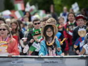 Lake Shore Elementary School third-grader Madison Nguyen, 9, center, honors the country of Vietnam while leading classmates along the parade route  May 27 at Fort Vancouver National Historic Site.