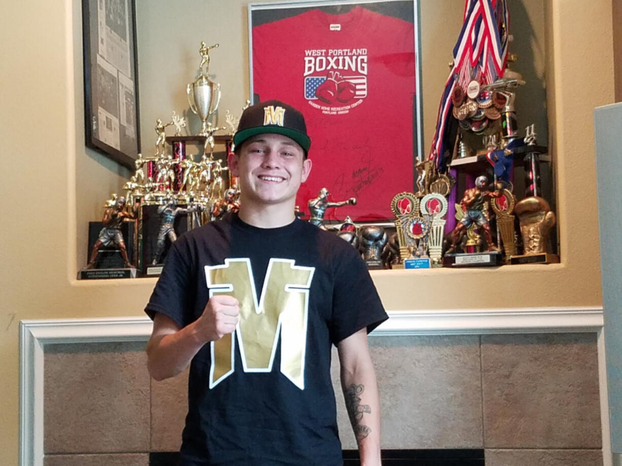 Vancouver boxer Victor Morales stands in front of a trophy collection at his Vancouver home.