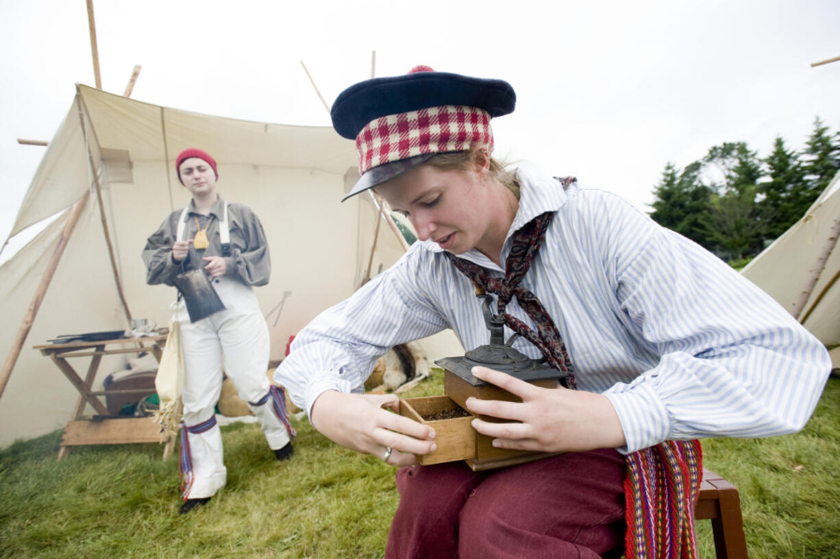 Jennifer Hutchinson makes coffee from freshly roasted beans at the brigade encampment reenactment in 2010 at Fort Vancouver.