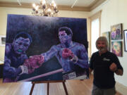 Painter Robert Hope stands with his painting of late legend Ali.