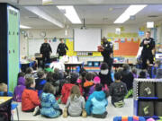 Officers from the Vancouver Police Activities League at Burton Elementary School for the league&#039;s final literacy event of the school year, where they read to kids, hand out free books and give a safety presentation.