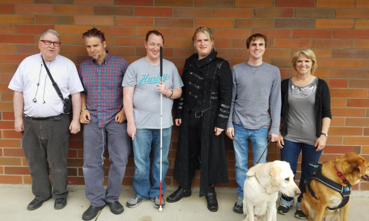 Piano Hospital director of instruction Don Mitchell, from left, student Jim Jackson, class of 2016 graduates Justin Dixson and Stefan Kincaid, student Blake Hardin and teacher Lori Amstutz. In front are guide dogs Beethoven, left, and Sparky.