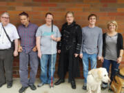 Piano Hospital director of instruction Don Mitchell, from left, student Jim Jackson, class of 2016 graduates Justin Dixson and Stefan Kincaid, student Blake Hardin and teacher Lori Amstutz. In front are guide dogs Beethoven, left, and Sparky.