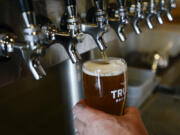 Gary Paul, the owner of Trusty Brewing Co., pours his lauded Corner Window IPA at his Vancouver brewery on Thursday afternoon.