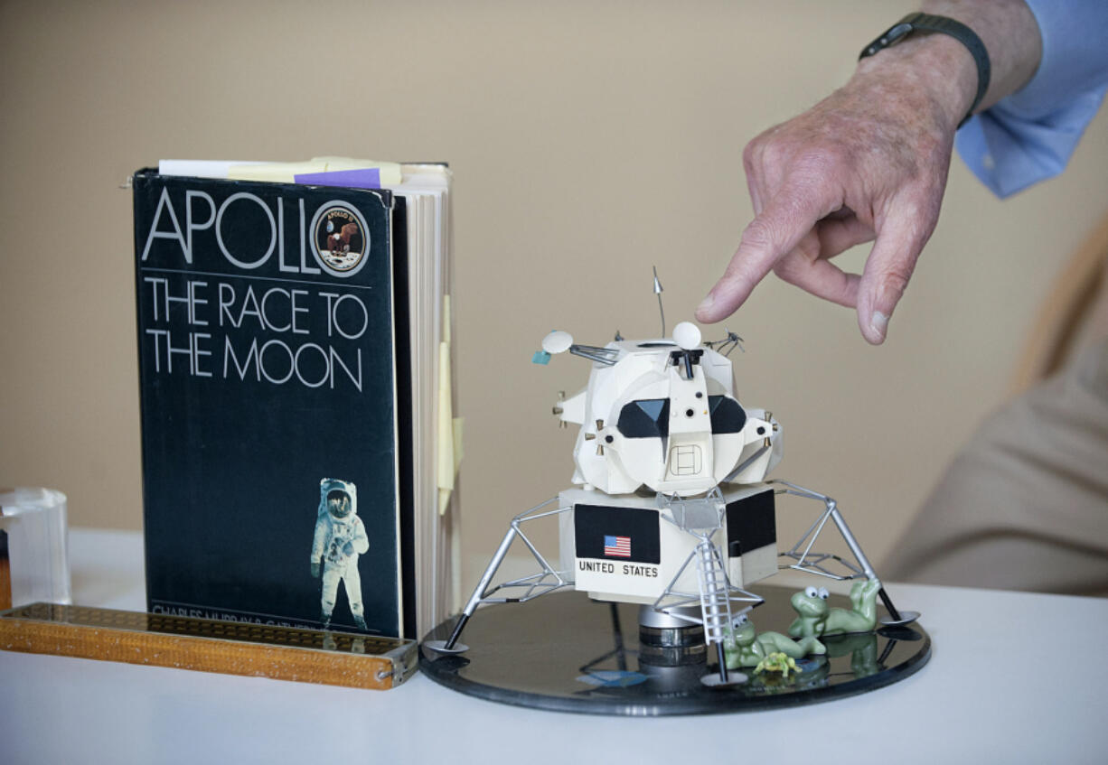 Using a model of the lunar lander, Cline Frasier describes some of the early technological challenges in putting men on the moon.