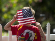 A little boy looks through the fabric of his American flag as he attends an Independence Day parade in Ridgefield.