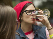 Vancouver native Mary Andersen, now living in Portland, samples wine from one of the 20 wineries participating in the Craft Beer &amp; Winefest at Esther Short Park in 2013.