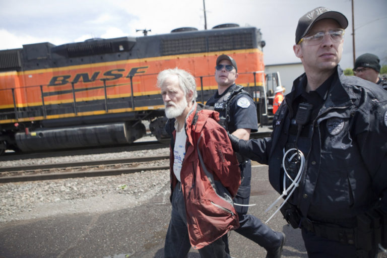 A protester is arrested at Saturday&#039;s demonstration in Vancouver.