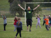 Timbers defender Nat Borchers joins students as they celebrate a goal while playing soccer Thursday afternoon, at Burton Elementary School.