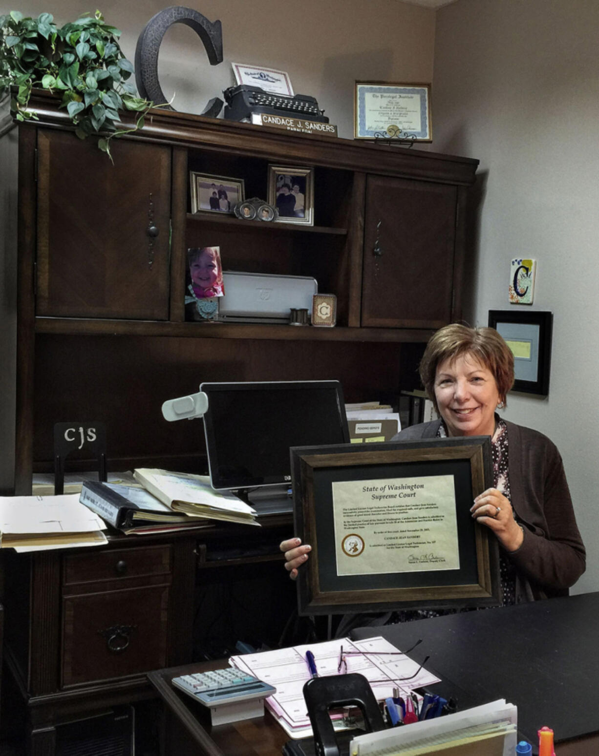 Candace Sanders displays her Limited License Legal Technician certificate in her Longview office in January. It allows her to provide family legal assistance with no law degree.