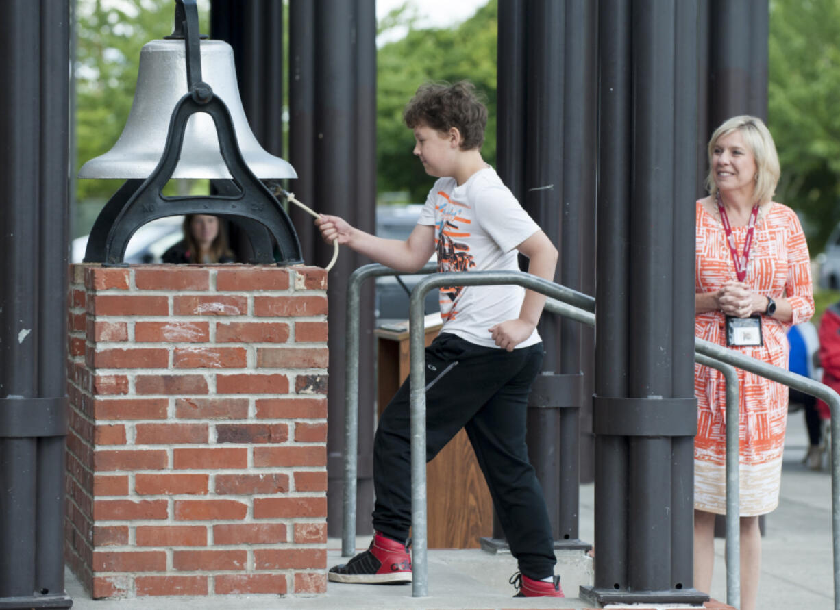 Nicholas Zook was the last fifth-grader to ring the bell at Hazel Dell Elementary School on Thursday morning. The longtime tradition of ringing the old school bell marks the last day of the school year. Principal Mychael Irwin officiates.