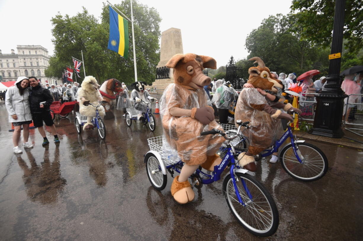 Characters in the royal parade in The Mall during &quot;The Patron&#039;s Lunch&quot; celebrations Sunday marking the Queen&#039;s 90th birthday. (Ben A.