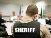 New Clark County Sheriff recruit Ethan Ogdee, center, listens during a meeting before the graveyard shift at the Clark County Sheriff West Precinct in Ridgefield on April 15.