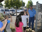 Gause Elementary School students visit, and high five, Washougal Mayor Sean Guard on a field trip where they learned about different services the city provides while visiting City Hall, the library and police and fire stations.