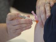 A nurse administers a flu shot in December at Legacy Salmon Creek Medical Center in Vancouver. Clark County's influenza season is over, local health officials said Wednesday.