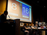 Competition moderator Mark Ray asks a question to the Witches of the West and Tiger&#039;s Quest teams during the Vancouver Public School District Battle of the Books at the Vancouver Community Library on Saturday.