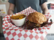 A bowl of house-made chili and a MooOink burger are served June 17 at the Old Ivy Brewery &amp; Taproom in downtown Vancouver.