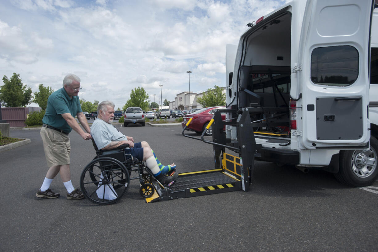 Mike Davis, left, of St. Chris MediVan helps Harold Richardson as he drops him off for an appointment at Summit Chiropractic &amp; Massage on Wednesday morning.