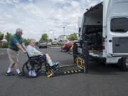 Mike Davis, left, of St. Chris MediVan helps Harold Richardson as he drops him off for an appointment at Summit Chiropractic &amp; Massage on Wednesday morning.