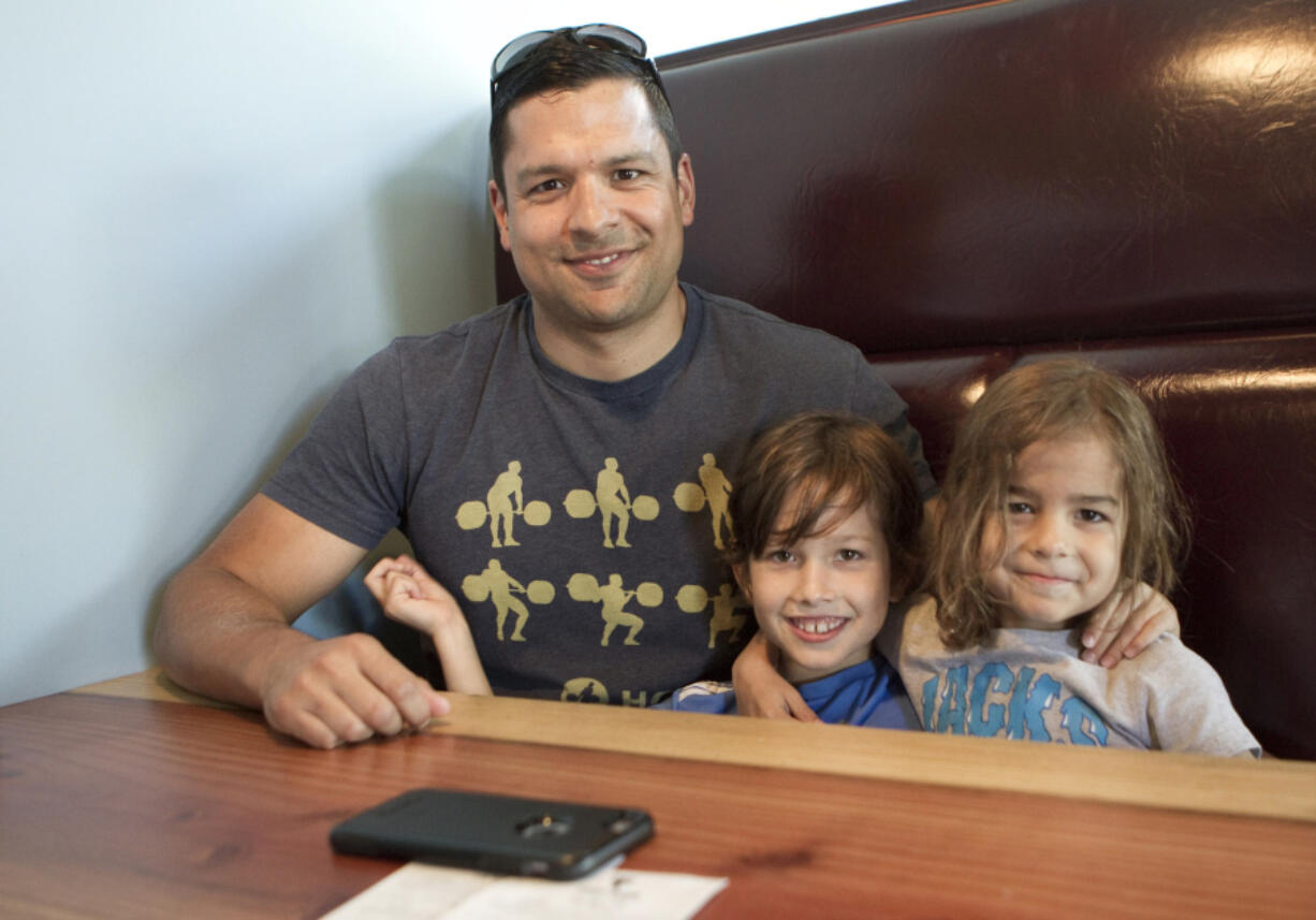 Nate Stanton, left, enjoys a trip for beer and tacos on Sunday with his boys, John, 8, center, and Jack, 5, at Trap Door Brewing on Main Street in Vancouver. Stanton said his typical Father&#039;s Day includes relaxation and spending time with the kids.