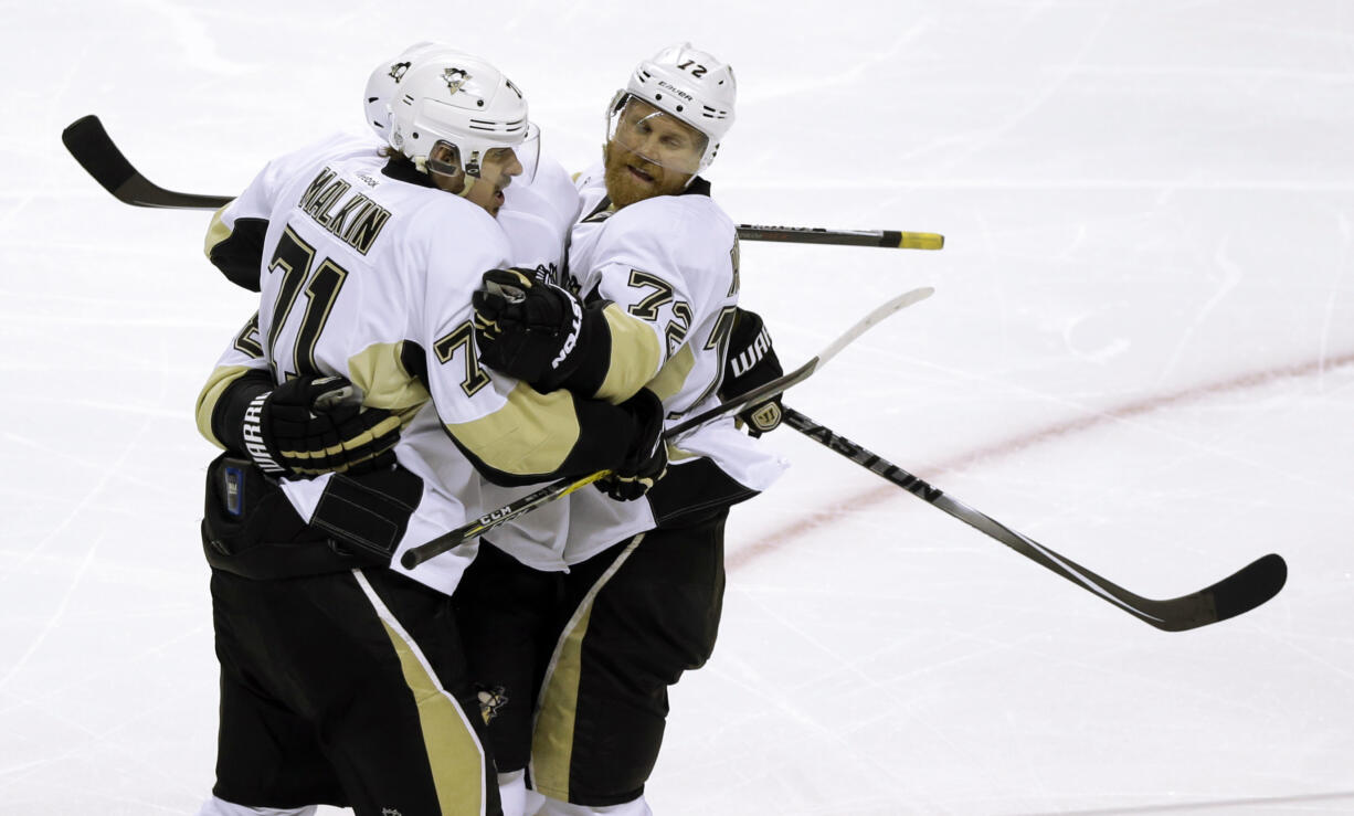 Pittsburgh Penguins' Evgeni Malkin, left, celebrates with Patric Hornqvist (72) after scoring a goal against the San Jose Sharks during the second period of Game 4 of the NHL hockey Stanley Cup Finals, Monday, June 6, 2016, in San Jose, Calif.