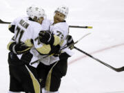 Pittsburgh Penguins' Evgeni Malkin, left, celebrates with Patric Hornqvist (72) after scoring a goal against the San Jose Sharks during the second period of Game 4 of the NHL hockey Stanley Cup Finals, Monday, June 6, 2016, in San Jose, Calif.