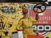 Joey Logano celebrates after winning the NASCAR Sprint Cup series auto race at Michigan International Speedway, Sunday, June 12, 2016 in Brooklyn, Mich.