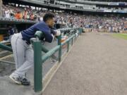 Seattle Mariners' Robinson Cano looks from the dugout after the Detroit Tigers defeated the Mariners in the 10th inning of a baseball game, Thursday, June 23, 2016, in Detroit.