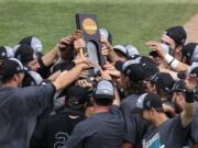 Coastal Carolina players celebrate their 4-3 victory over Arizona to win the championship after Game 3 of the NCAA College World Series baseball finals in Omaha, Neb., Thursday, June 30, 2016.