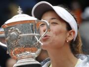 Spain's Garbine Muguruza is to kiss the cup after defeating Serena Williams of the U.S.  in their final match of the French Open tennis tournament at the Roland Garros stadium, Saturday, June 4, 2016 in Paris.  Muguruza won 7-5, 6-4.