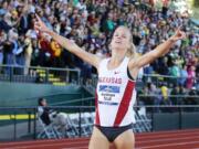 Arkansas' Dominique Scott points as she wins the women's 5,000 meters at the NCAA outdoor track and field championships in Eugene, Ore., Saturday, June 11, 2016.