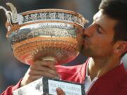 Serbia's Novak Djokovic kisses the cup after defeating Britain's Andy Murray in their final match of the French Open tennis tournament at the Roland Garros stadium, Sunday, June 5, 2016 in Paris.