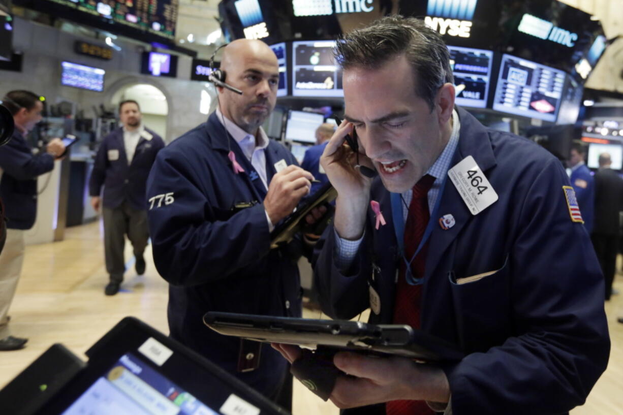 Traders Gregory Rowe, right, and Fred DeMarco work on the floor of the New York Stock Exchange on Friday. U.S. stocks are plunging in early trading after Britons voted to leave the European Union.